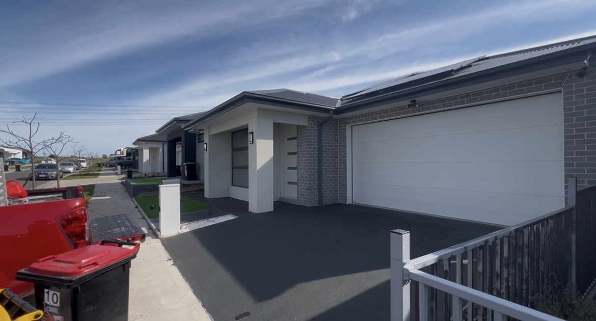 Recently completed dark sealed concrete driveway