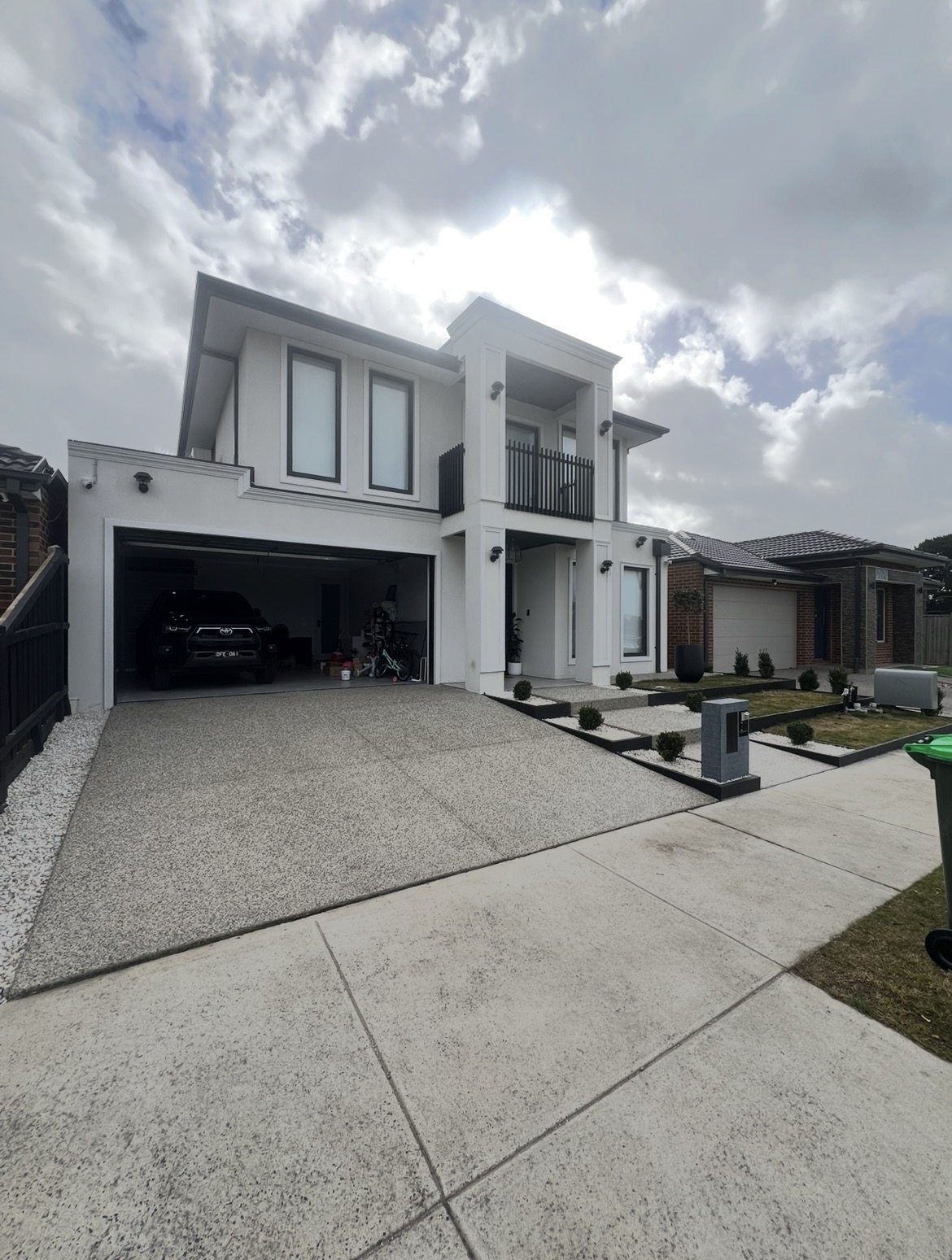 Modern residential concrete driveway and home